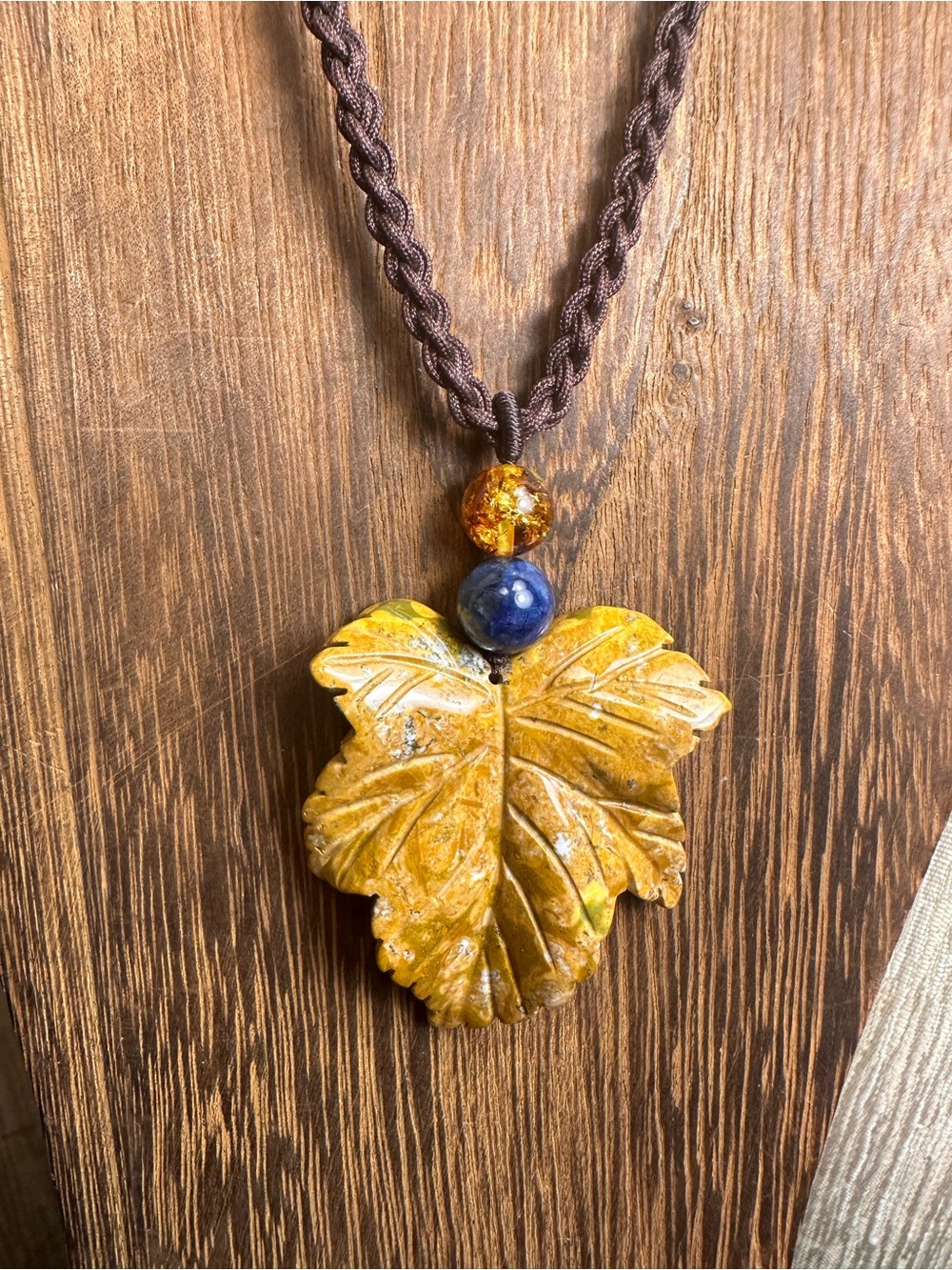 Yellow Ocean Jasper Leaf Carving Pendant Necklace on Brown Braided Rope - Picture 4 of 13